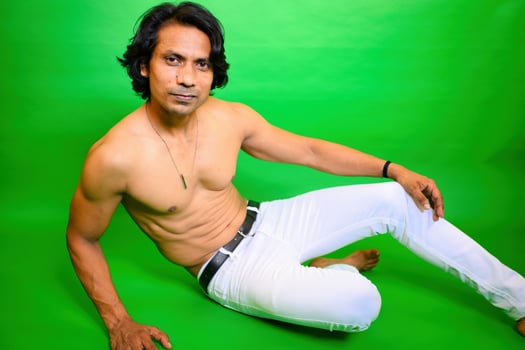 Smiling Shirtless man on floor posing photo
