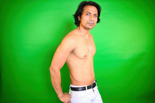 Shirtless man posing against green background photo