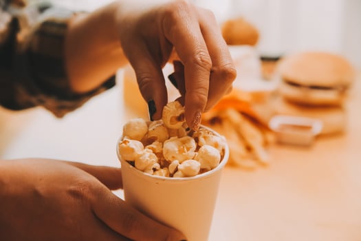 A woman holding a bowl of popcorn photo