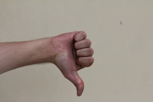 Thumb down male hand sign isolated photo