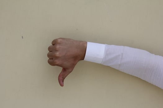 Thumb down male hand sign isolated photo