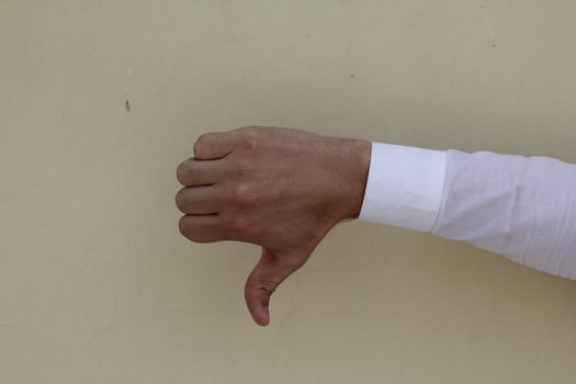 Thumb down male hand sign isolated photo