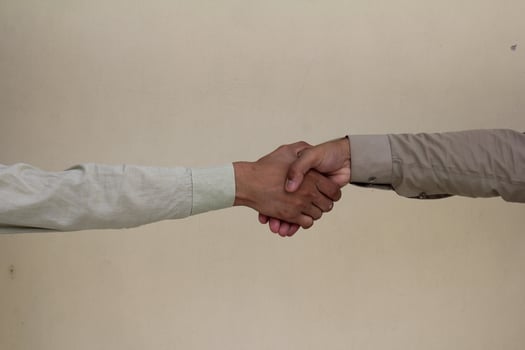 Close up two man shaking hand on white background.Athletes shaking hands before sports competition. Unity and teamwork concept. photo