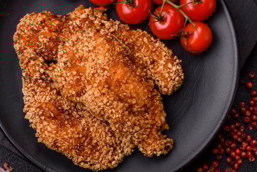 Delicious fresh crispy chicken nuggets on a dark concrete background photo