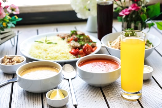 Table Adorned With Assortment of Bowls Filled With Food and Drinks photo