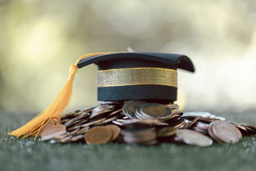 Graduation from college with university degree in finance marked successful culmination of education, envisioning value of each coin invested. coin, college, education, graduation, hat, school. photo