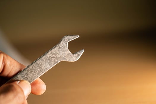 A detailed close-up of a silver crowbar resting on a wooden surface photo
