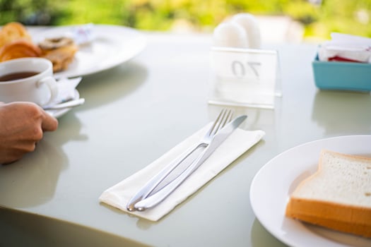 Breakfast table with bread, coffee, and cutlery photo