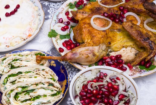 Different food on a wooden table, grilled chicken legs, buffalo wings, salad, photo
