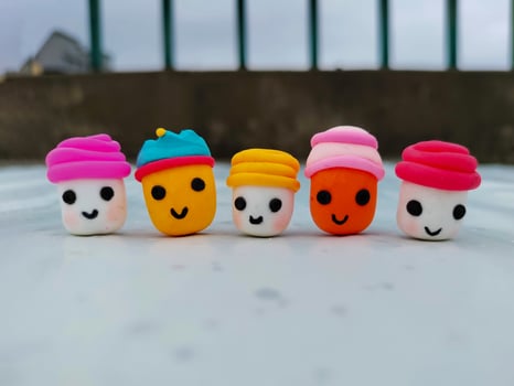 Cute Handmade Clay Plasticine Cartoon Faces on White Background photo