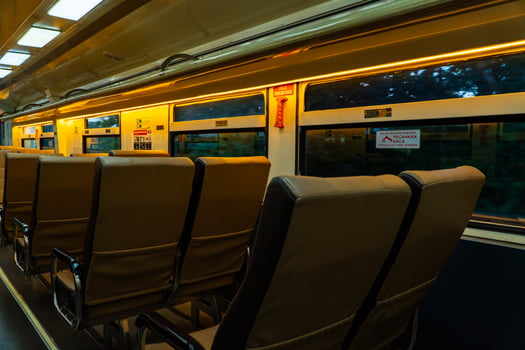 Public trains in Java, Indonesia are empty of passengers in the afternoon when the sun sets. The train carriage was quiet and many passenger seats were empty photo