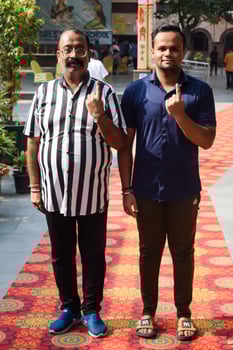 New Delhi, India - May 25 2024 - Unidentified people showing their ink-marked fingers after casting votes in front of polling booth of east Delhi area for general Lok Sabha Elections 2024 photo