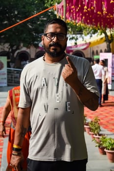 New Delhi, India - May 25 2024 - Unidentified people showing their ink-marked fingers after casting votes in front of polling booth of east Delhi area for general Lok Sabha Elections 2024 photo