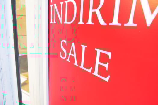 Large Sale text letters on red background on clothing store . photo