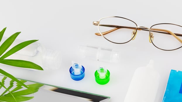 Contact lens kit with bottle of lens solution, container and eye drops photo