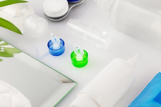 Contact lens kit with bottle of lens solution, Container, case and eye drops photo