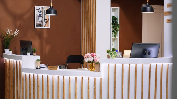 Stylish hotel reception desk and lounge area equipped with trendy extravagant decorations and lighting, providing inviting ambiance for hotel clients. Luxurious and comfy holiday getaway. photo