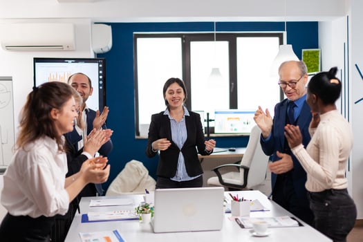 Happy creative business team having meeting in broadroom office victory overjoyed. Multiethnical partners coworkers celebrate successful teamwork result at company briefing photo