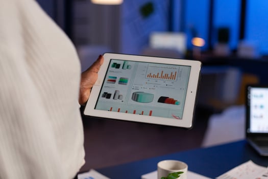 Closeup of african american entrepreneur analyzing company profit checking financial graphs reports using laptop computer. workaholic black businesswoman overworking in startup office at night photo