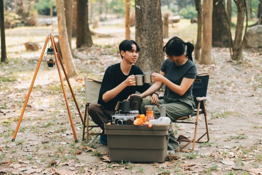 Asian couple sweet in tent inside on they camping trip, traveller relax and sleep togather in out door and camping trip photo