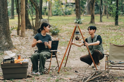 Asian couple sweet in tent inside on they camping trip, traveller relax and sleep togather in out door and camping trip photo