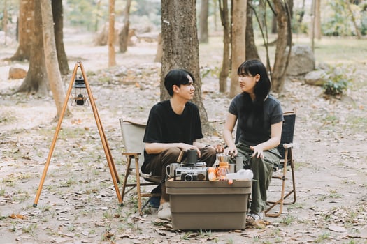 Asian couple sweet in tent inside on they camping trip, traveller relax and sleep togather in out door and camping trip photo