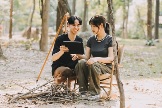Asian couple sweet in tent inside on they camping trip, traveller relax and sleep togather in out door and camping trip photo