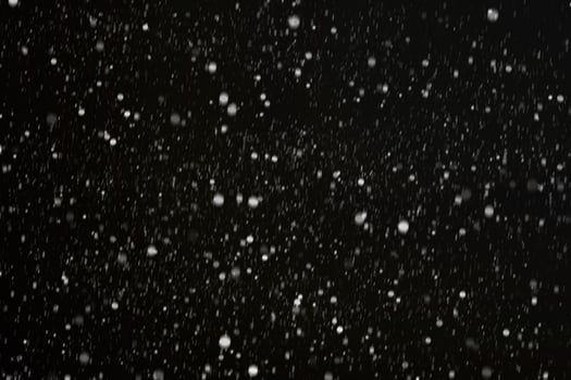 White snow on a black background texture. photo
