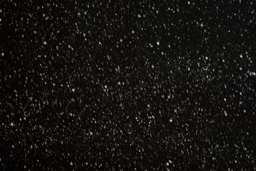White snow on a black background texture. photo
