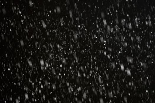White snow on a black background texture. photo