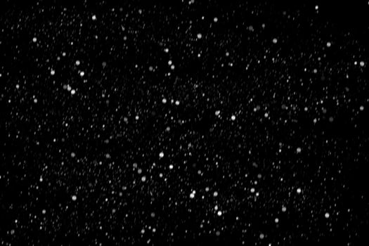 White snow on a black background texture. photo