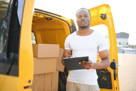 Delivery man near shipping mini van. photo