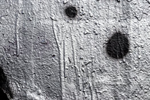 Fragment of silver graffiti painted on a wall. photo