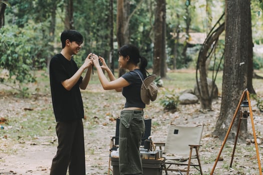 Asian couple sweet in tent inside on they camping trip, traveller relax and sleep togather in out door and camping trip photo