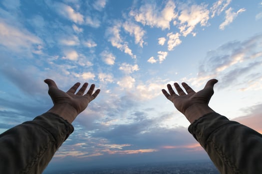 man raised her hands above her head to ask for mercy from God in accordance with her belief in God in Christianity. man raising both hands to ask for blessings from God according to beliefs photo