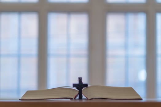 cross is placed on the Bible after prayer to God, which is religious ritual of Christianity and belief in the teachings of God. concept of praying to God with the teachings of the Bible and cross. photo