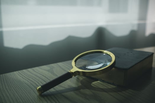 A Bible and a magnifying glass are placed on a wooden table after praying to God Christian religious ritual and belief in the teachings of God. Ideas for praying to God with teachings from the Bible photo