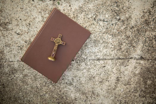 cross is placed on the Bible after prayer to God, which is religious ritual of Christianity and belief in the teachings of God. concept of praying to God with the teachings of the Bible and cross. photo