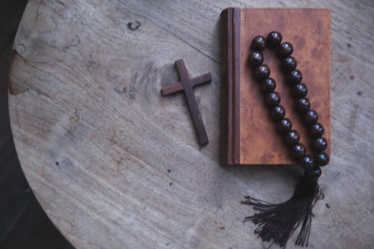 cross is placed on the Bible after prayer to God, which is religious ritual of Christianity and belief in the teachings of God. concept of praying to God with the teachings of the Bible and cross. photo