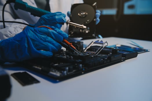 Close up of Technician measuring voltage electronic circuit board television, Service after sale fix electric equipment within insurance. photo