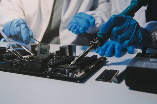 Close up of Technician measuring voltage electronic circuit board television, Service after sale fix electric equipment within insurance. photo