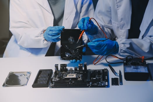 Close up of Technician measuring voltage electronic circuit board television, Service after sale fix electric equipment within insurance. photo