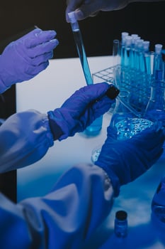 chemist,scientist hand dropping chemical liquid into test tube, science research and development concept photo