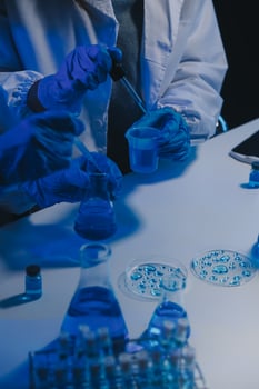 chemist,scientist hand dropping chemical liquid into test tube, science research and development concept photo