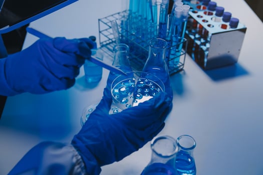 chemist,scientist hand dropping chemical liquid into test tube, science research and development concept photo