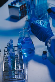 chemist,scientist hand dropping chemical liquid into test tube, science research and development concept photo
