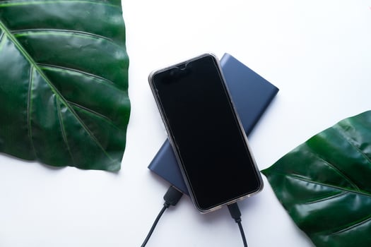 charging smartphone with power bank, high angle view photo