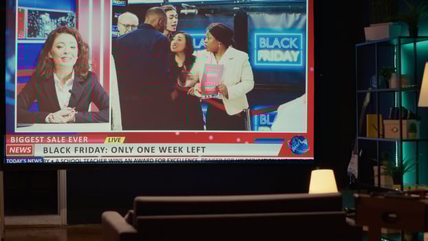 Empty apartment built as home theatre with ultrawide smart TV showing news broadcast about black friday sales frenzy. VOD channel showing newscaster talking about store bargains reportage photo