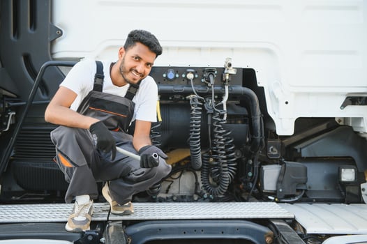 Indian Mechanic repairing the truck photo