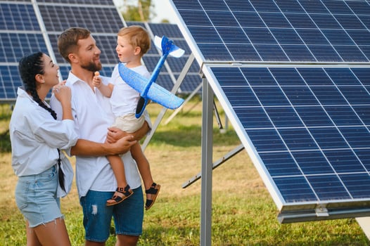Happy family near solar panels. Alternative energy source photo